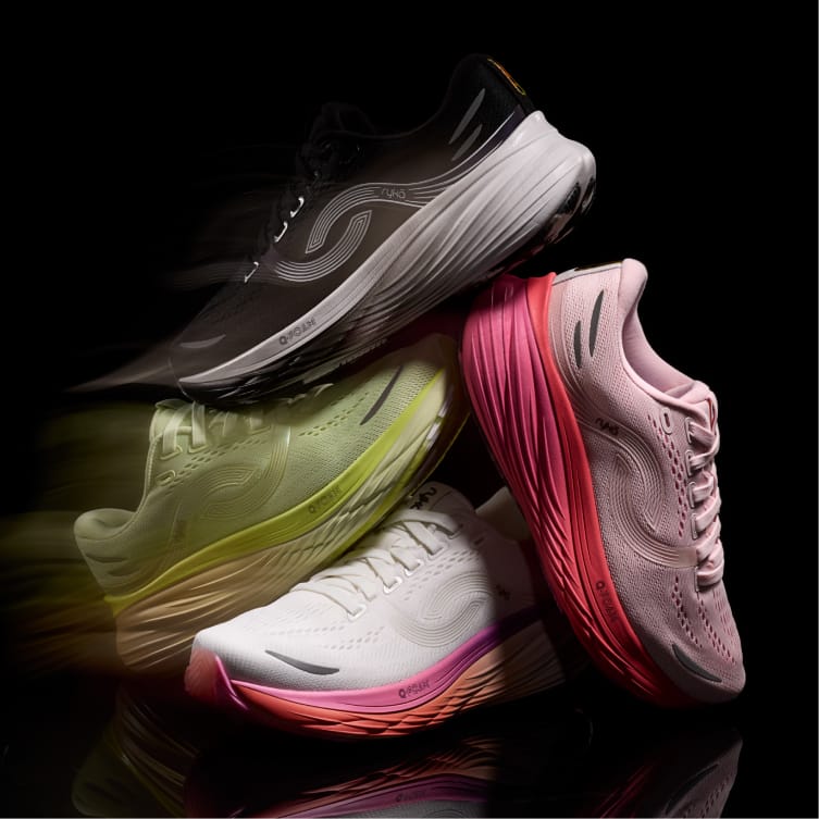 Four stacked sneakers on a black background