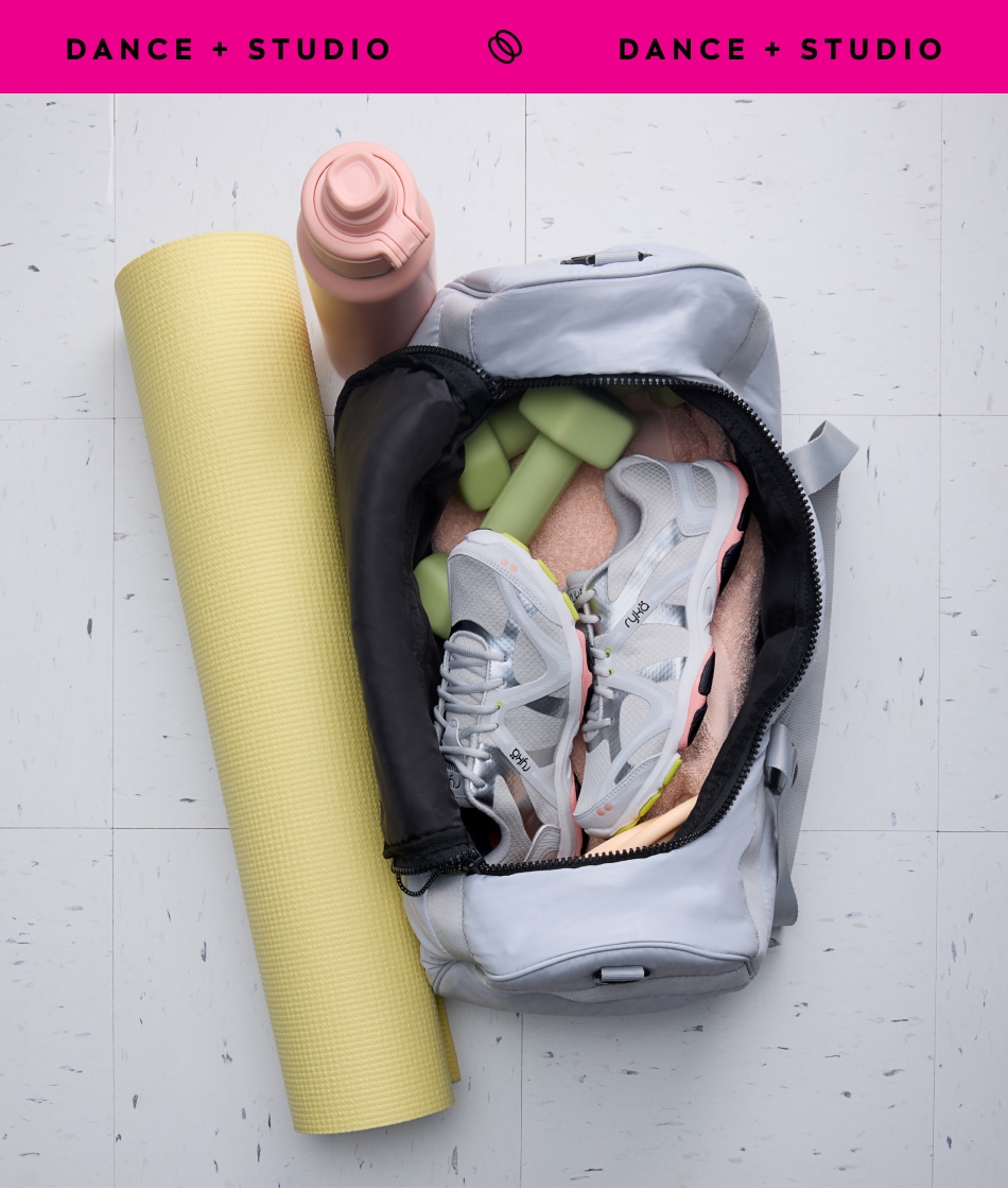 A yoga mat, water bottle, and gym bag containing a pair of white sneakers with silver accents. A pink banner at the top says 