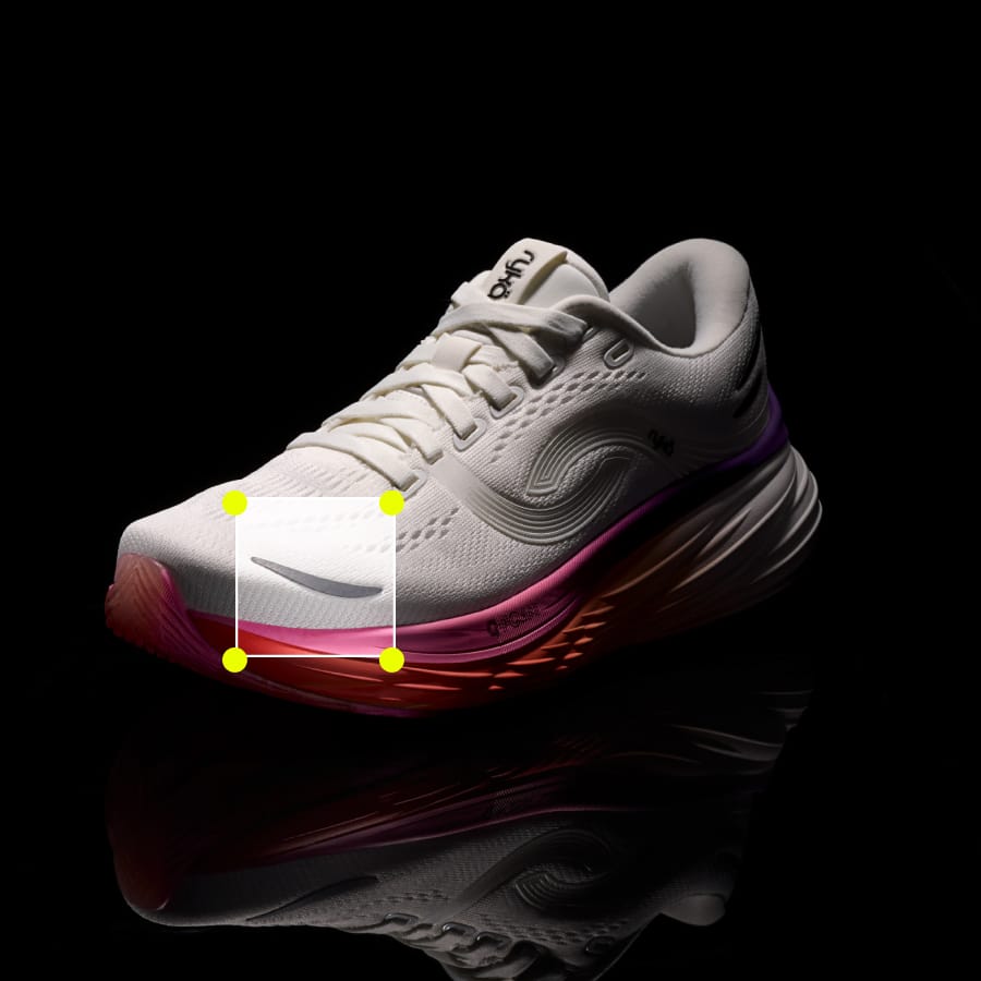 Pink and white women's running sneaker on a black background with a square at the toe highlighting the fabric. 