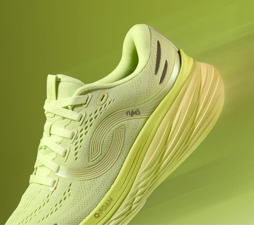 A bright green women's running sneaker displayed at an angle on a green background. 