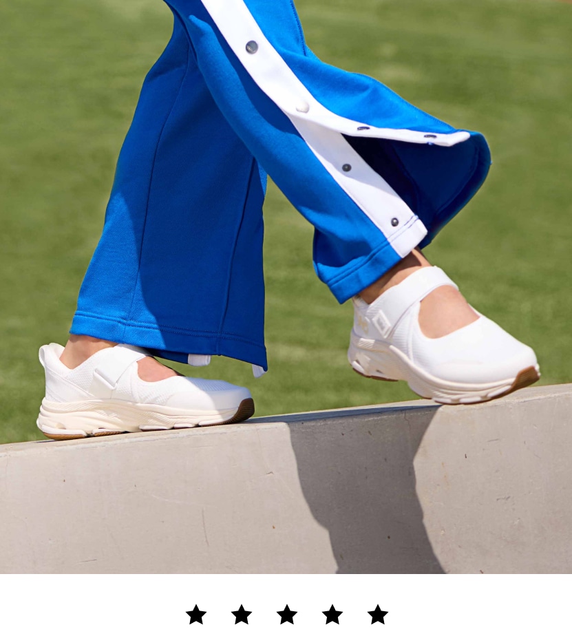 A model wearing white Rykä Devotion Max Mary Jane shoes while walking