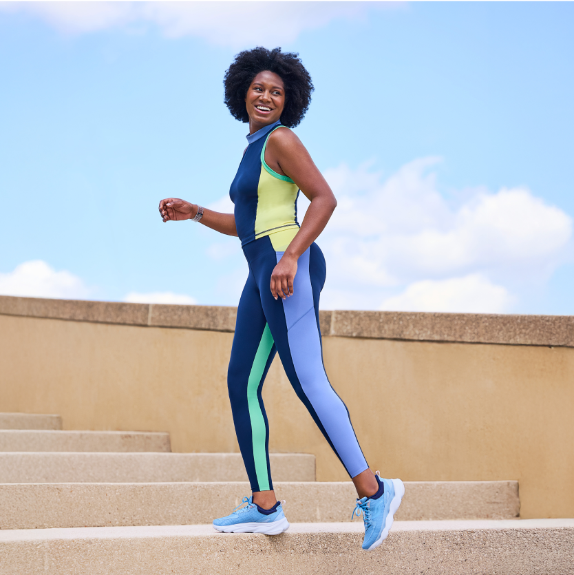 A model wearing Rykä Rezorb Max shoes while walking up stairs
