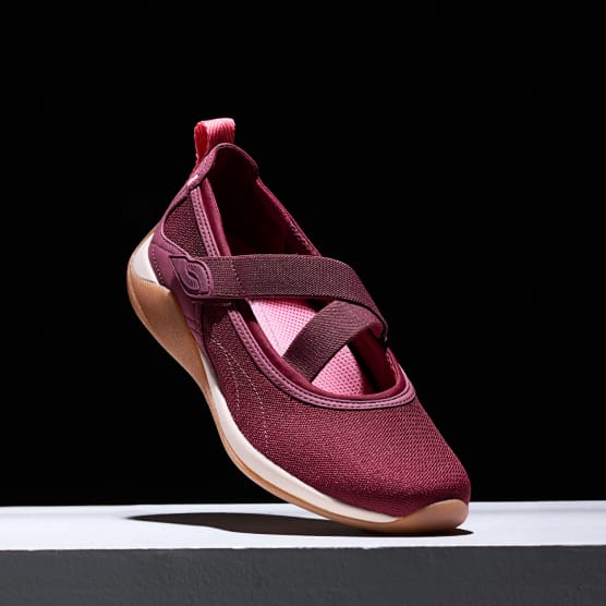 Women's burgundy Mary Jane sneaker displayed at an angle on a black background.