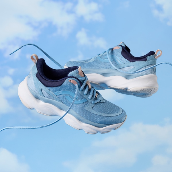 A pair of light blue Rykä Rezorb Max shoes over a cloudy background